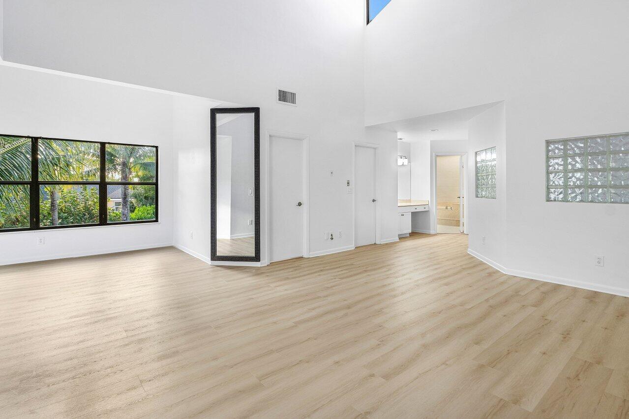 5109 North Ocean Boulevard, Unit H Ocean Ridge, FL 33435 - Photo 22 of 45 wooden floor in an empty room with a window
