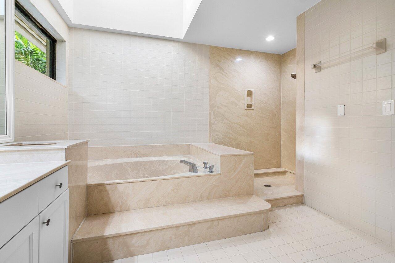 5109 North Ocean Boulevard, Unit H Ocean Ridge, FL 33435 - Photo 28 of 45 a bathroom with a bathtub and a sink