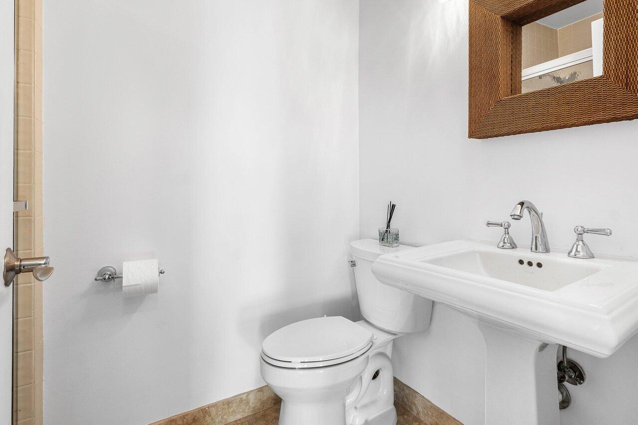 5109 North Ocean Boulevard, Unit H Ocean Ridge, FL 33435 - Photo 33 of 45 a bathroom with a toilet a sink and mirror