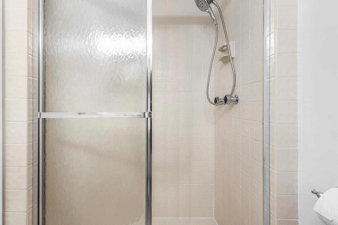 5109 North Ocean Boulevard, Unit H Ocean Ridge, FL 33435 - Photo 34 of 45 a bathroom with a glass shower door
