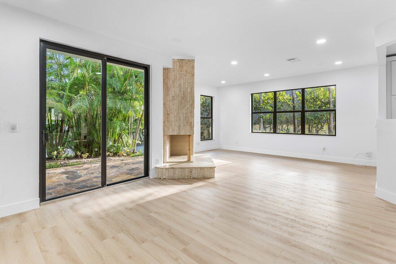 5109 North Ocean Boulevard, Unit H Ocean Ridge, FL 33435 - Photo 8 of 45 an empty room with wooden floor and windows