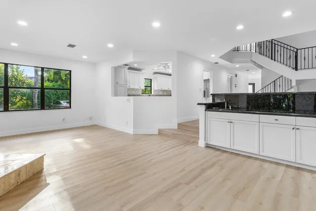 a view of an empty room with a window and a fireplace