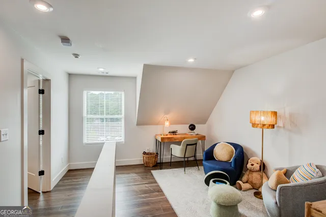 a living room with furniture a rug and a large window