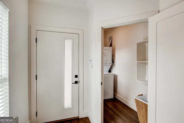 a view of hallway with stairs and wooden floor