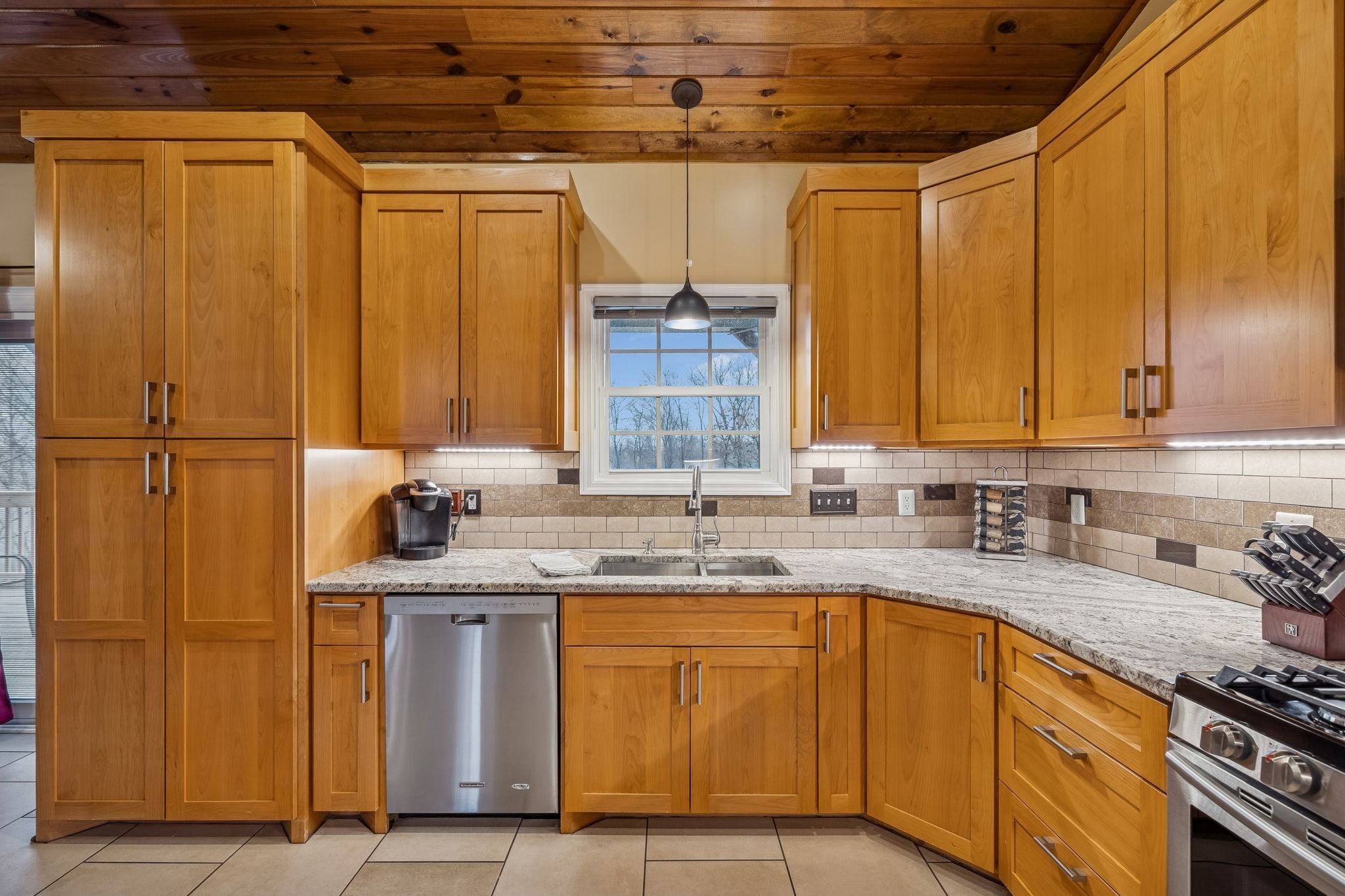 9200 Dobbs Cemetery Road Baxter, TN 38544 - Photo 22 of 85 a kitchen with stainless steel appliances granite countertop a sink window and cabinets