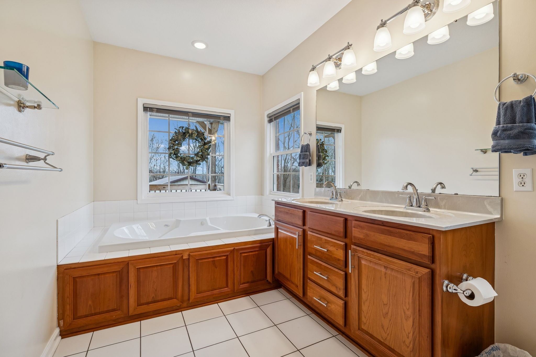 9200 Dobbs Cemetery Road Baxter, TN 38544 - Photo 32 of 85 a spacious bathroom with a granite countertop sink a toilet a mirror and bathtub