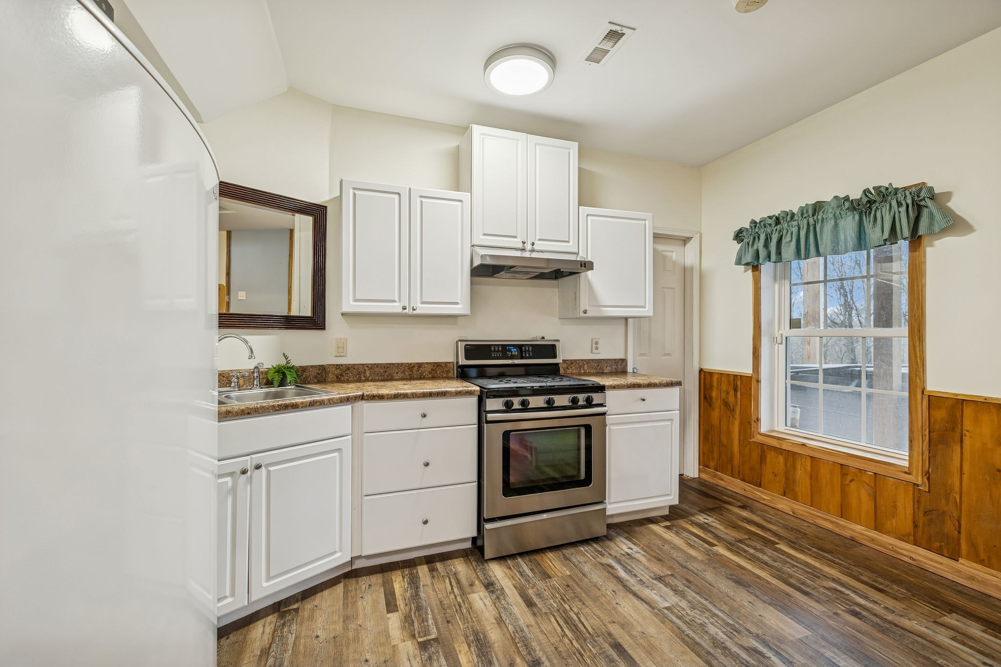 9200 Dobbs Cemetery Road Baxter, TN 38544 - Photo 44 of 85 a kitchen with stainless steel appliances granite countertop a stove a sink and a refrigerator