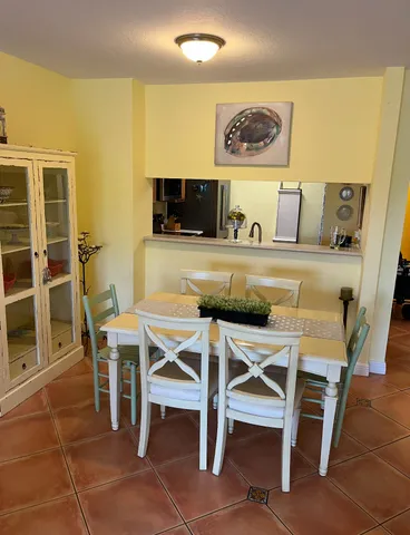 a dining area with a table and chairs