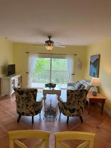 a living room with fireplace furniture and a large window
