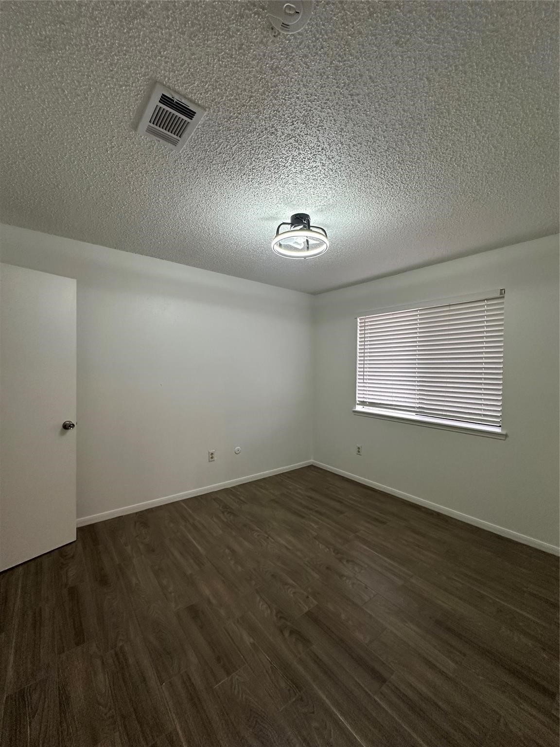 1410 Blalock Road, Unit 9 Houston, TX 77055 - Photo 11 of 18 an empty room with wooden floor and windows