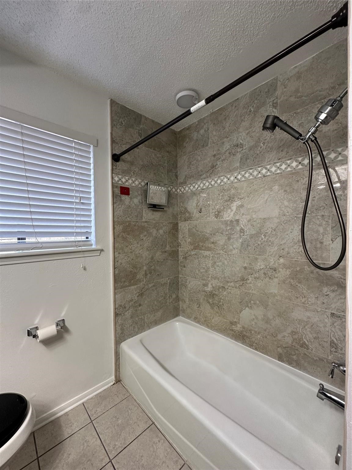 1410 Blalock Road, Unit 9 Houston, TX 77055 - Photo 14 of 18 a bathroom with a granite countertop bathtub and a shower