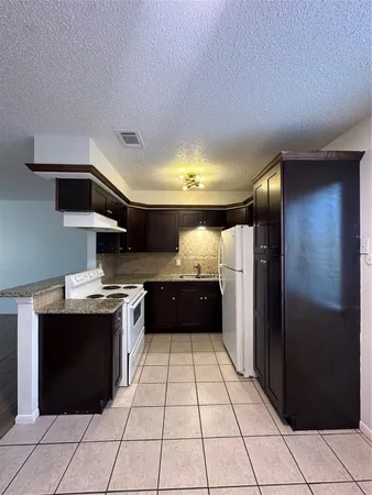 a kitchen with a sink a stove and refrigerator
