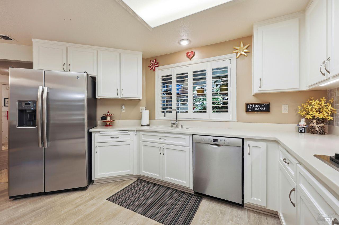 2092 Stonefield Lane Santa Rosa, CA 95403 - Photo 10 of 44 a kitchen with granite countertop white cabinets and stainless steel appliances