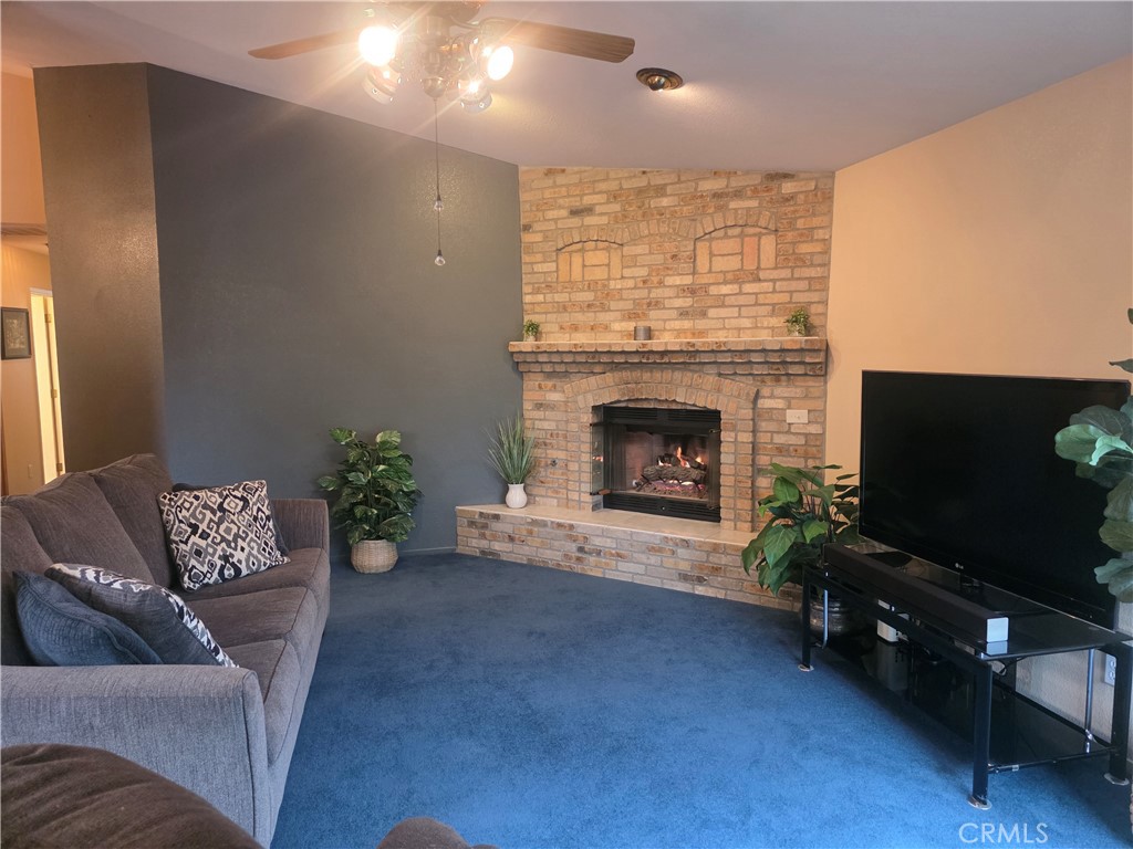 1618 Charlie Lane Santa Maria, CA 93454 - Photo 25 of 57 a living room with furniture a flat screen tv and a fireplace