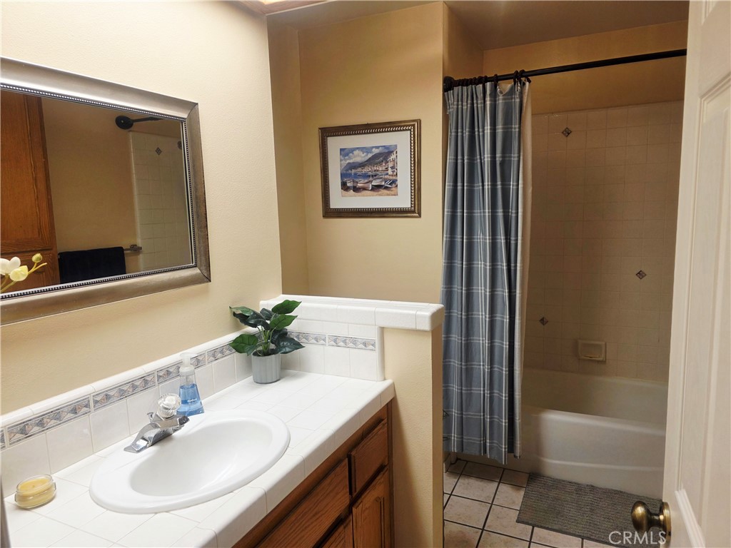 1618 Charlie Lane Santa Maria, CA 93454 - Photo 28 of 57 a bathroom with a granite countertop sink and a mirror