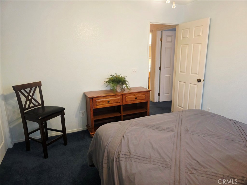 1618 Charlie Lane Santa Maria, CA 93454 - Photo 32 of 57 a bedroom with a bed and a chair