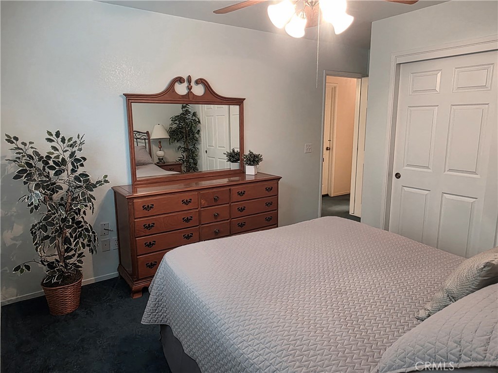 1618 Charlie Lane Santa Maria, CA 93454 - Photo 33 of 57 a bedroom with a bed and a chandelier