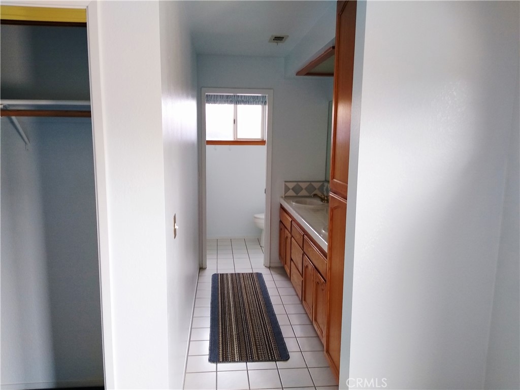 1618 Charlie Lane Santa Maria, CA 93454 - Photo 39 of 57 a view of a hallway with wooden floor and staircase