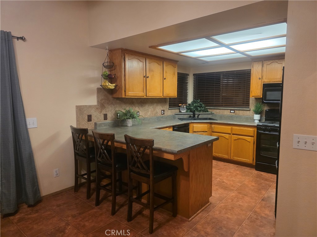 1618 Charlie Lane Santa Maria, CA 93454 - Photo 43 of 57 a kitchen with a sink a counter top space and cabinets
