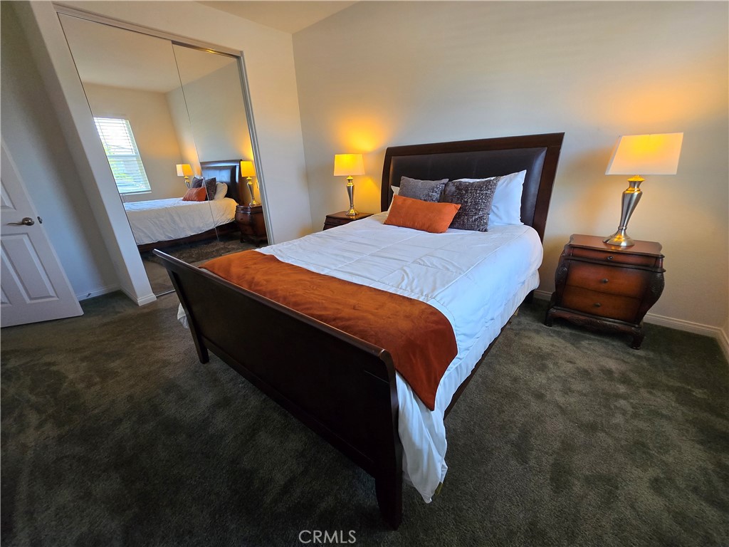7900 Raincross Court Riverside, CA 92507 - Photo 6 of 21 a bed sitting in a bedroom next to a lamp