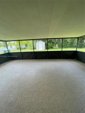 a view of an empty room with windows