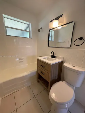 a bathroom with a sink a mirror and a toilet