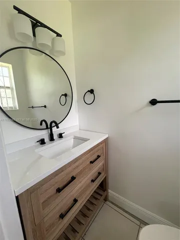 a bathroom with a sink and mirror