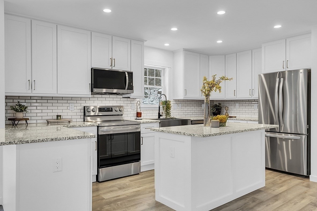 823 Carpenter Road Athol, MA 01331 - Photo 11 of 41 a kitchen with stainless steel appliances granite countertop a stove a sink and a refrigerator