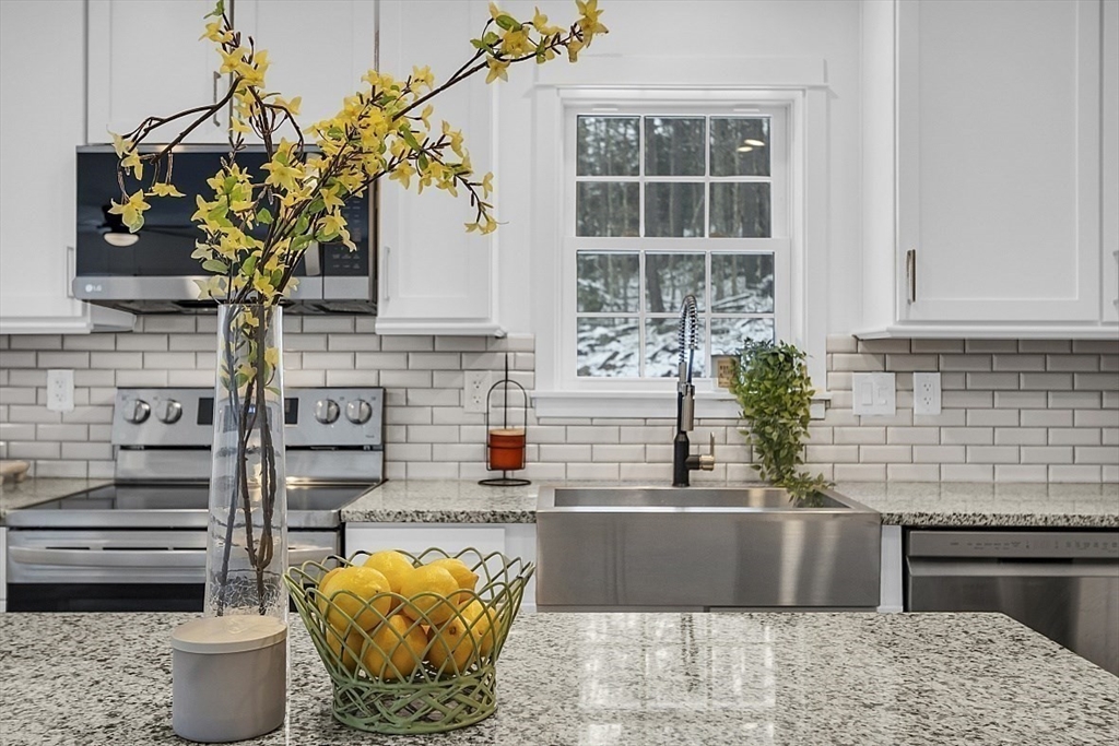 823 Carpenter Road Athol, MA 01331 - Photo 13 of 41 a kitchen with a stove and a potted plant