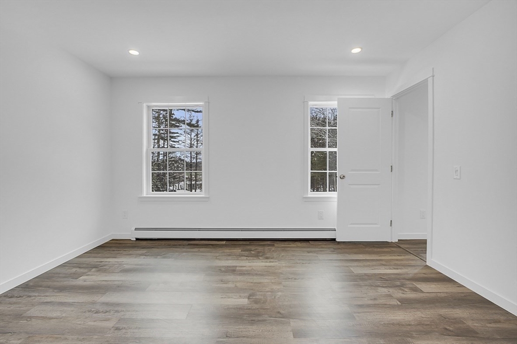 823 Carpenter Road Athol, MA 01331 - Photo 15 of 41 an empty room with wooden floor and windows