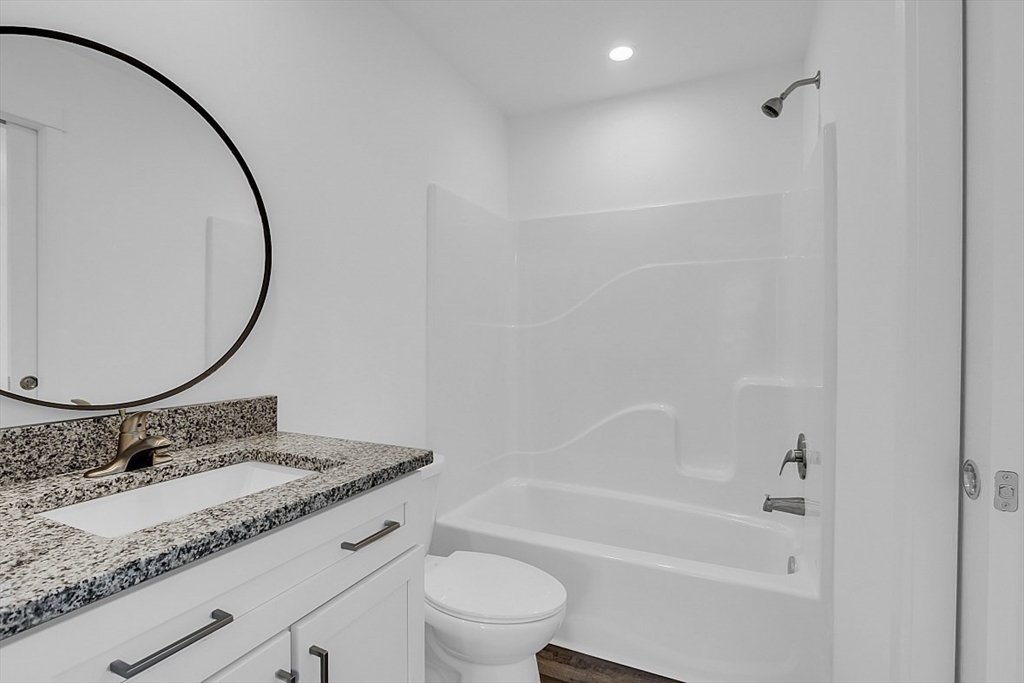 823 Carpenter Road Athol, MA 01331 - Photo 26 of 41 a bathroom with a granite countertop sink a toilet and a mirror
