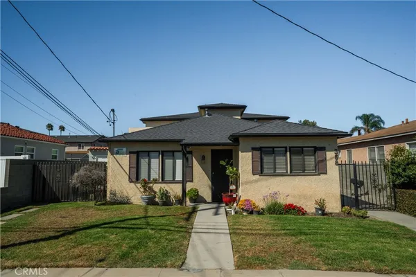 a front view of a house with a garden