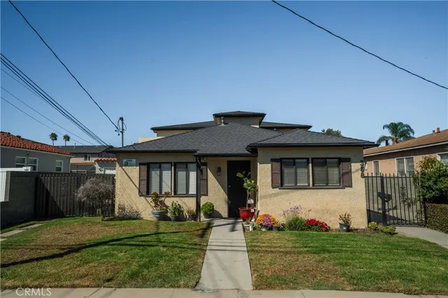 a front view of a house with a garden