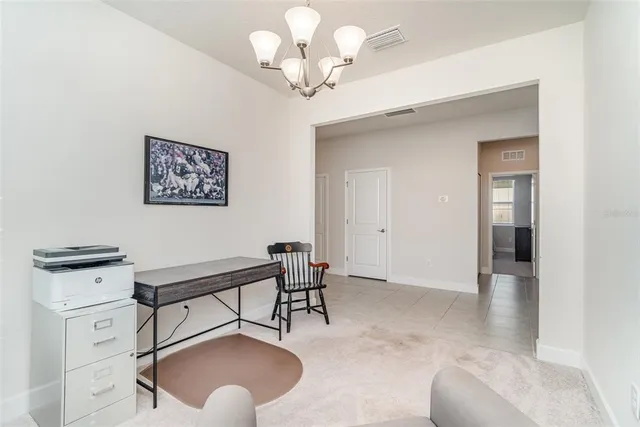 a view of a livingroom with furniture and chandelier fan
