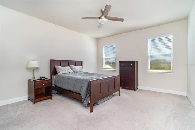 a bedroom with a bed dresser and a window