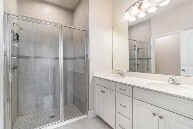 a bathroom with a shower sink and mirror