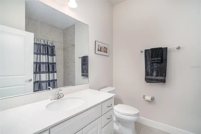 a bathroom with a sink vanity mirror and toilet