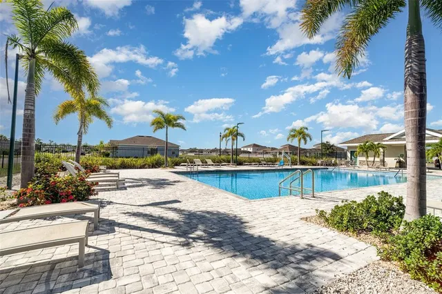 a view of swimming pool with outdoor seating