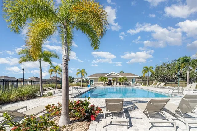 a view of swimming pool with outdoor seating