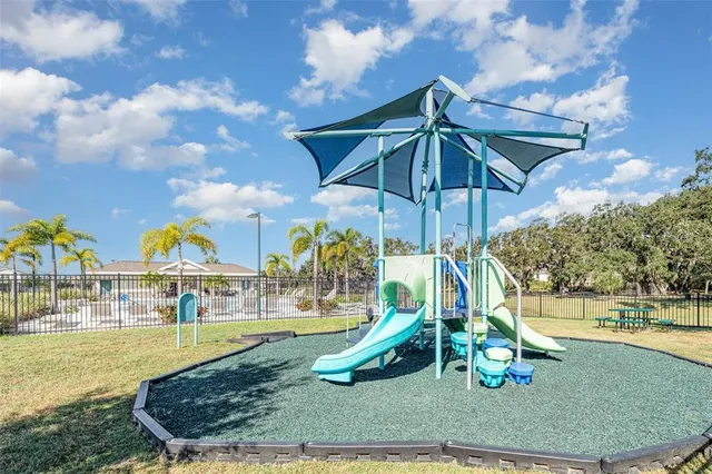 a view of outdoor space with playground and green space