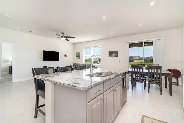 a open kitchen with stainless steel appliances granite countertop a sink and a refrigerator