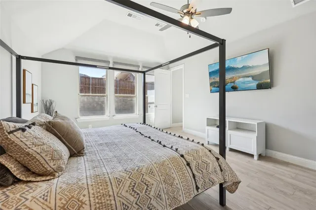 a bedroom with a large bed and a window