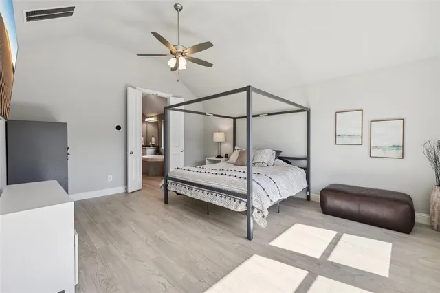 a bedroom with a bed and ceiling fan