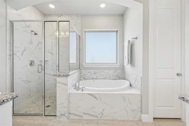 a bathroom with a bathtub and a shower