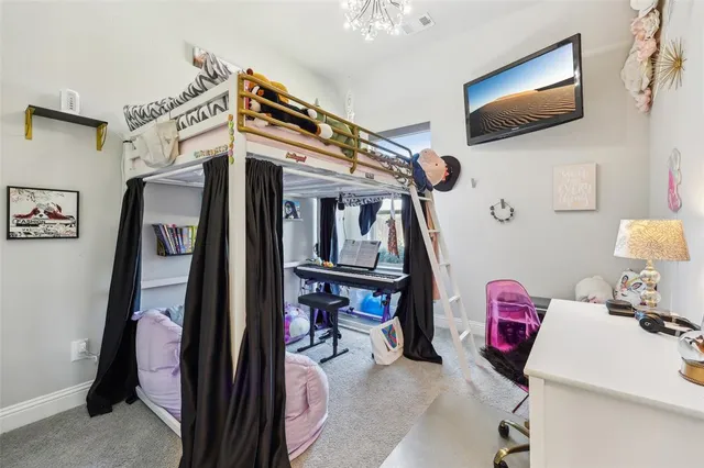 a bedroom with furniture and a flat screen tv