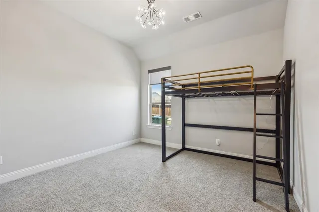 a view of room with stairs and a chandelier