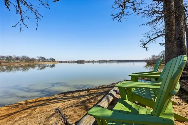 a view of a lake with a table and a chairs