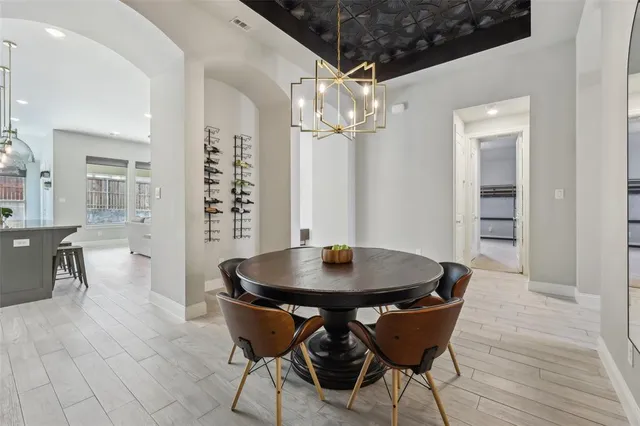 a view of a dining room with furniture and chandelier