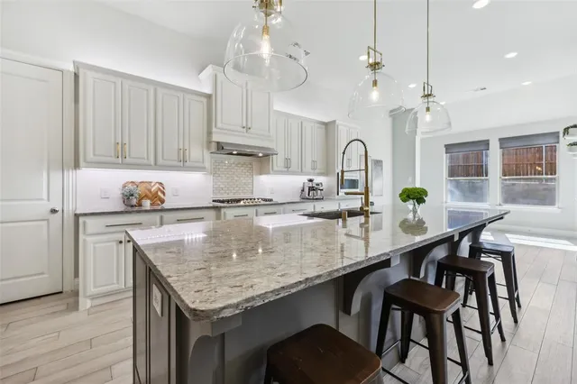 a kitchen with a table chairs and cabinets
