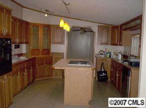 2515 Hinson Road Monroe, NC 28112 - Photo 5 of 8 a kitchen with refrigerator and cabinets